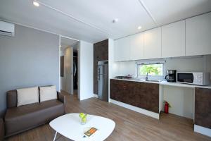 a kitchen and living room with a couch and a table at Camping Porto srl in Moniga