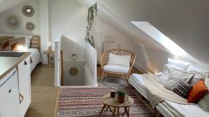 a living room with a couch and a chair at Le cosy marnais, centre ville, vue cathédrale in Reims