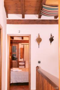 a hallway leading to a bedroom with a bed at CASA RURAL EL PIÑON in Jerte