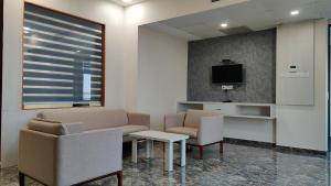 a waiting room with two chairs and a tv at Vadpadraka Hotel And Resort in Vadodara