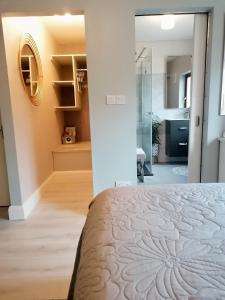 a bedroom with a bed and a bathroom at No 12 B&B in Dungarvan