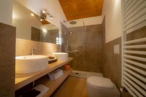 a bathroom with a sink and a toilet at Alta Luce Mountain Lodge in Gressoney-la-Trinité