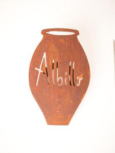 a brown vase with the word alittle written on it at Los Tinajones in Colmenar de Oreja