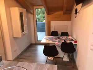 a kitchen with a table and chairs in a room at Ferienwohnung am Freibad in Schwarzach