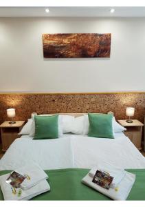 A bed or beds in a room at Zenit Panzió