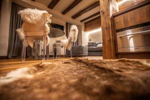 a living room with a couch and a table at L.A. SUITE Courmayeur in Courmayeur +25 photos