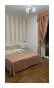 Postel nebo postele na pokoji v ubytování Bed and Breakfast Nonna Loreta