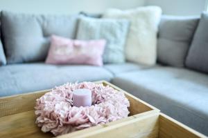 a candle sitting on a table in front of a couch at Sternadelshof in Großgrabe