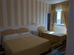 Postel nebo postele na pokoji v ubytování Bed and Breakfast Nonna Loreta