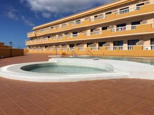a building with a pool in front of a building at Apto Tagoro, La Restinga in La Restinga