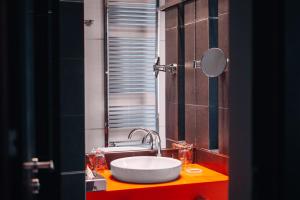 a bathroom with a sink and a mirror at Boutique Hotel Townhouse 27 in Belgrade