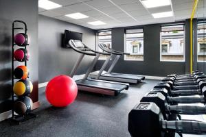 a gym with tread machines and a red ball in a room at SENS Høtel in Montréal