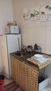 a kitchen with a sink and a refrigerator at Lapa II Cultura Museus e Praias no Centro GR in Rio de Janeiro