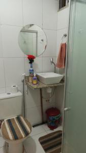 a bathroom with a toilet and a sink and a mirror at Lapa II Cultura Museus e Praias no Centro GR in Rio de Janeiro