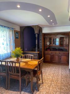 a dining room with a wooden table and chairs at Grisli house in Gauja