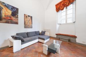 a living room with a couch and a table at Pontevecchio Luxury Suite AMAZING LOCATION - hosted by Sweetstay in Florence