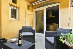 a bottle of wine sitting on a table on a patio at Pontevecchio Luxury Suite AMAZING LOCATION - hosted by Sweetstay in Florence
