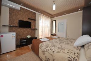 a hotel room with a bed and a television at Apartments 4 seasons in Ohrid