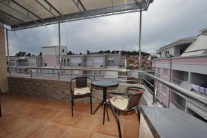 a balcony with a table and chairs on a roof at Apartments 4 seasons in Ohrid