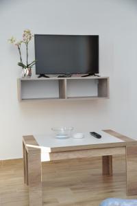 a living room with a tv and a coffee table at Apartmani Krstojević Kopaonik in Kopaonik