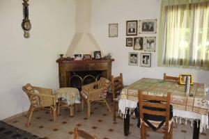 a dining room with a table and chairs and a fireplace at Lovely cottage with garden !!!!! in Kariá