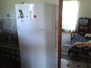 a white refrigerator in a kitchen with a window at Lovely cottage with garden !!!!! in Kariá