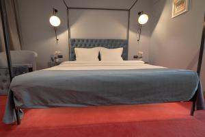 a bedroom with a large bed with two pillows at Vitosha Park Hotel - Free Indoor Pool & Parking in Sofia