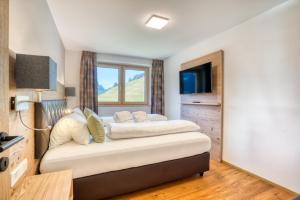 Postel nebo postele na pokoji v ubytování HUS23 with Wellness