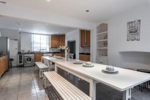 a kitchen with a large white island in a room at Large Central Brighton Townhouse Close to Pier in Brighton & Hove