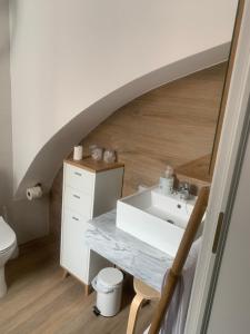 a bathroom with a sink and a toilet at Puerta de Caceres Apartamento 5 Callejón De Don Álvaro in Cáceres
