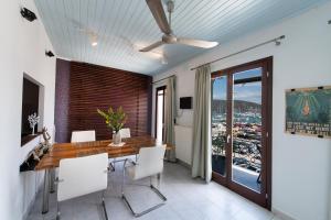 a dining room with a table and a ceiling fan at LefkasLoft in Lefkada Town