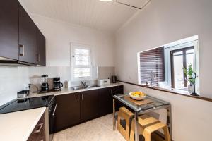 a kitchen with a table and a counter top at LefkasLoft in Lefkada