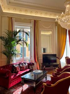 a living room with a red couch and a television at Palazzo Monga Boutique Guesthouse in Verona