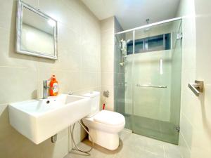 a bathroom with a toilet and a sink and a shower at Solstice Cyberjaya by Easy Property in Cyberjaya