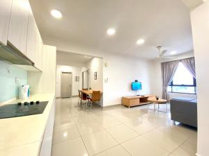 a kitchen and living room with a couch and a table at Solstice Cyberjaya by Easy Property in Cyberjaya