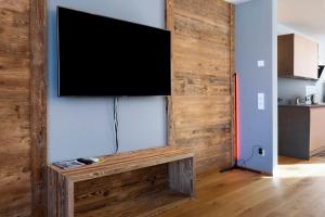 a flat screen tv hanging on a wall at Noreia Granda in Ortisei