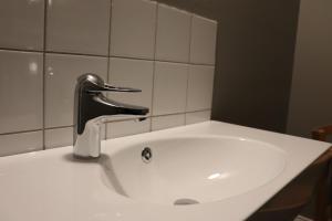 a sink with a faucet in a bathroom at STF af Chapman & Skeppsholmen in Stockholm