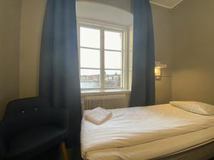 a bedroom with a bed and a window at STF af Chapman & Skeppsholmen in Stockholm