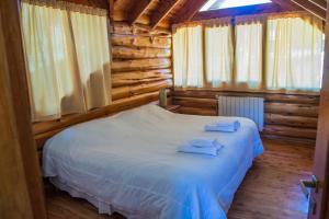 Postel nebo postele na pokoji v ubytování Cabañas Ruca Kuyen Golf & Resort + 49 fotografií