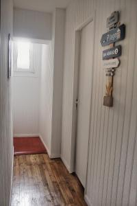un pasillo con una puerta y un cartel en la pared en Le 8 ∙ Appartement cosy avec balcon vue sur mer, en Mers-les-Bains