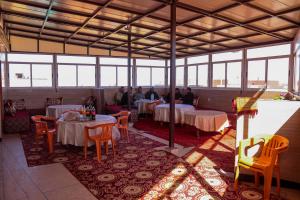 a group of people sitting at tables in a restaurant at Hotel Palace Zaida in Zeïda