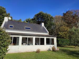 une maison blanche avec beaucoup de fenêtres dans l'établissement Pascanono - Location de maison de vacances avec jardin pour séjour à Le Palais, Belle-Ile-en-mer, au Palais