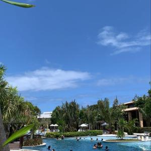 a group of people in a pool at a resort at Apartamento flat - Iloa Residence 1 in Barra de São Miguel +14 photos