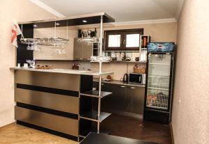 a kitchen with a counter and a refrigerator at Tbilisi Tower Apartment in Tbilisi City