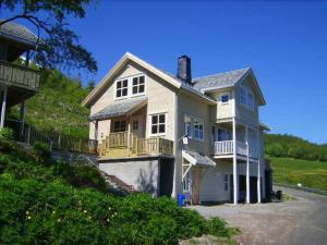 a large house on the side of a hill at Hesthaug Gard in Eidsdal