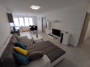 a living room with a couch and a tv at APARTMÁNY BYTČA in Bytča