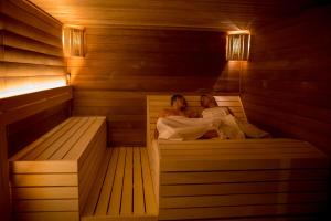 two women laying in a sauna at Hotel Kras in Jedovnice