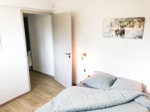 Ένα ή περισσότερα κρεβάτια σε δωμάτιο στο Résidence Altitude 1700