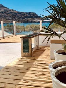 a wooden deck with a view of the ocean at Notus Suites in Plakias