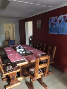 a dining room with a wooden table and chairs at Bloekomhuis in Smithfield +8 photos